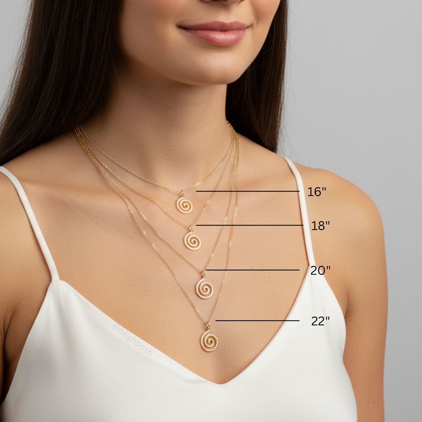 Woman wearing gold spiral necklaces with measurements indicated on a gray background