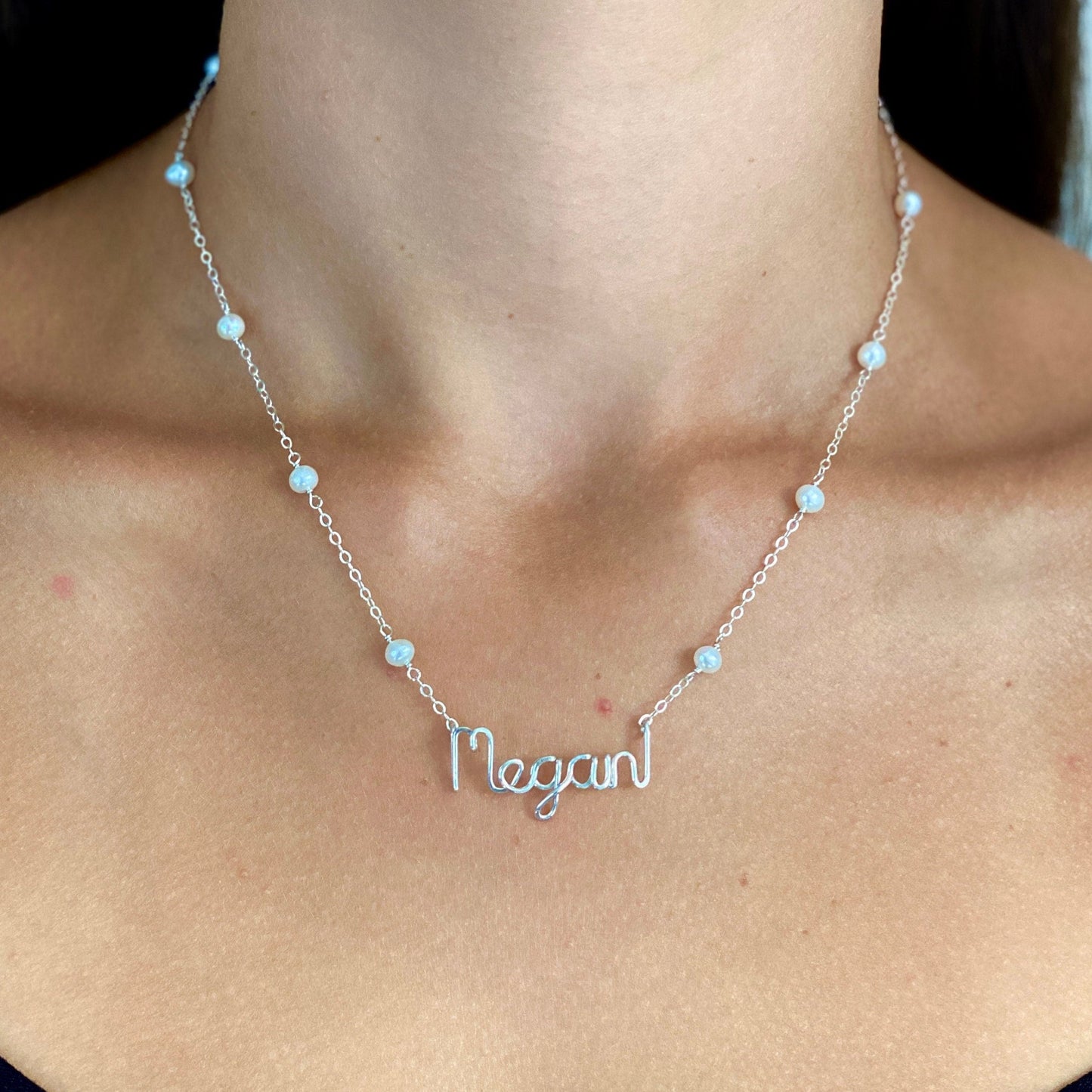 Name Necklace. Off White Freshwater Pearl Name Necklace in Sterling Silver. Script style font.