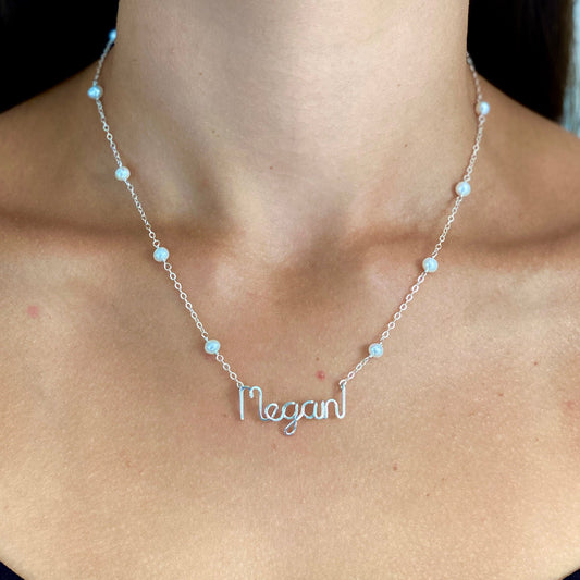 Name Necklace. Off White Freshwater Pearl Name Necklace in Sterling Silver. Script style font.