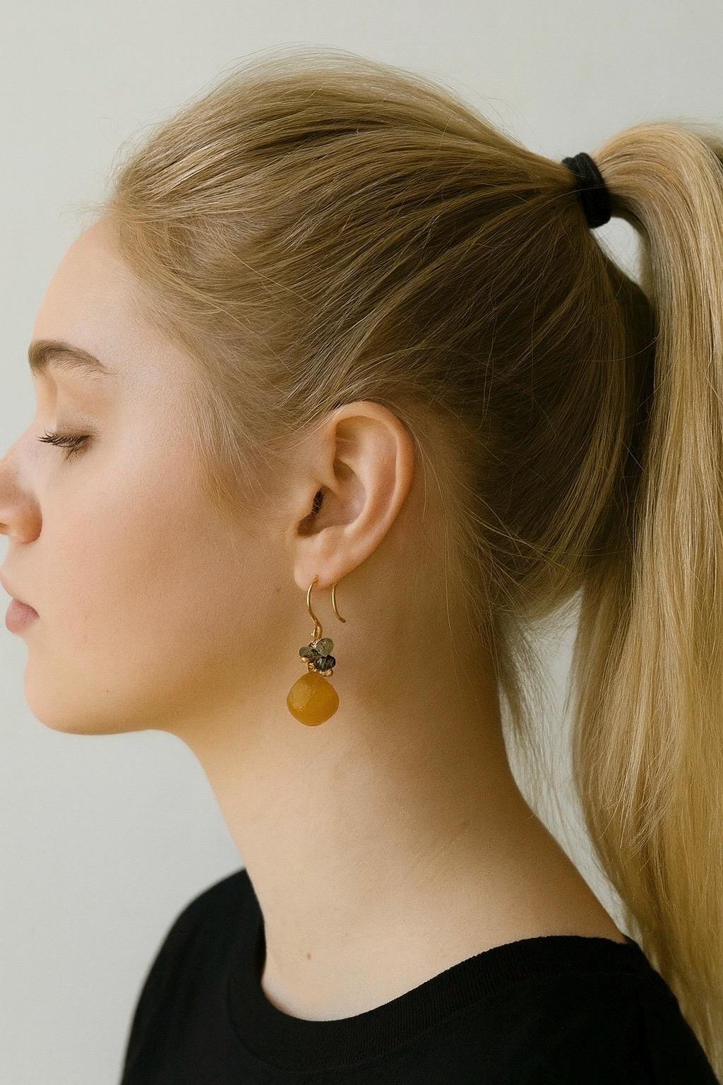 Woman wearing a black top with a plain background